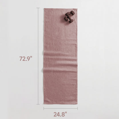 Pink towel with dimensions and dumbbells on a light gray background